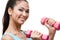 Athletic young woman exercises with dumbbells