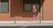 Athletic young woman jogging in the city early in the morning.
