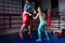 Athletic young woman in sportswear and in boxing gloves training