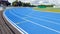 Athletics running blue track in a sports stadium