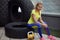 Athletics, after training with tyre. Smiling young female sportswoman sitting on a tire