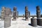 Atlantean figures and ancient pillars against blue sky at the arc