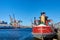 Atlantic Basin, Red Hook, NY showing the stern of an old oil tanker, gantry cranes and the skyline of Lower Manhattan