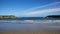 Atlantic Ocean bay with light waves, sandy beach in Spain