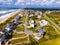 Atlantic Ocean coast in North Carolina. Sandy shore, rolling waves and line of low-rise houses and hotels along the coast