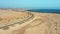 Atlantic ocean coastline. Aerial view of highway road, Corralejo sand beach, outskirts. Aerial landscape of city. Road