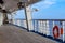 Atlantic Ocean - March 29 2014: Deck onboard Carnival Liberty cruise ship with orange life buoy hanging on side rail.