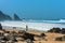 Atlantic ocean rocky coastline of Adraga beach with fisherman. Portugal