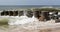 Atlantic ocean waves crashing into a jetty on the beach