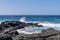 Atlantic ocean waves crashing over volcanic lava rocks on La Palma Island, Canary Islands, Spain