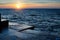 Atlantic sunset at the stone pier in calm weather. Nature.