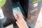 ATM and banking operations. Female hand enters the pin from the Bank card in the machine. Close up