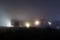 An atmopsheric edit of buildings on the edge of town, back lighted on a foggy night .UK