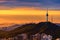 The atmosphere before the sunset at Bukchon hanok village, tourists dressed in hanbok to take pictures and watch the view because