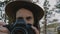 Atmospheric close-up portrait of young beautiful photographer girl with camera smiling at Yosemite park slow motion.