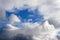 Atmospheric cyclone begins to close the blue sky clouds of various shapes and sizes