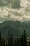 atmospheric and fairytale photo of high mountains covered with fog