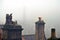 Atmospheric image of crows perched on chimneys in winter fog in hebden bridge west yorkshire