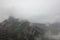 Atmospheric landscape in rainy weather. Gloomy landscape with a river among rocks. Stones with moss and lichen