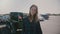 Atmospheric portrait of young beautiful smiling country woman with flying hair at big American car park slow motion.