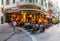 Atmospheric scene of people sitting at an Athens cafeteria late