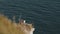 Atmospheric shot of beautiful white seagull sitting on the edge of white cliff, a gorgeous view of sea wildlife nature.