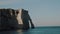 Atmospheric steadicam shot of famous epic Normandy white chalk arch cliffs, a picturesque panorama at sunset Etretat.