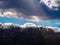 Atmospheric Storm Clouds Over A Mountain In The Blue Sky