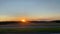 atmospheric video filmed in motion from a car driving along the highway overlooking the fields and the setting sun