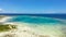 Atoll with turquoise water and boats.