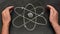 Atom symbol drawn on a blackboard