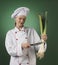 Atractive professional cook on green background