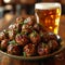 an atractive and tastefull image of meatballs portion and pint of beer together