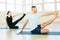 Atractive yoga couple , man and woman, practice exercises in a training hall