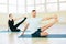 Atractive yoga couple , man and woman, practice exercises in a training hall