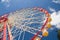 Atraktsion Ferris wheel against the blue sky