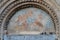 Atri, Teramo, Italy, August 2019: Fresco above the gate of the Cathedral of Atri, Basilica of Santa Maria Assunta.