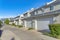 Attached garages of townhouses with concrete driveway at Daybreak, Utah