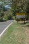 attention cyclists along the highway, written in Portuguese on a sign that is on a road, copy space to the left