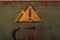 Attention sign in yellow triangle on rusty metal background. exclamation symbol