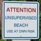 An attention unsupervised beach use at own risk sign