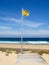 Attention, yellow flag on the beach