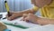 Attentive boy writing home work in copybook after school lessons, education