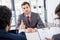 Attentive businessman listening to colleagues during job interview