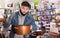 Attentive buyer inspects new pot in a hardware store