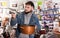 Attentive buyer inspects new pot in a hardware store