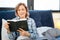 Attentive curious mature woman reading holy book