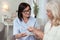 Attentive elder woman taking medication