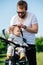 Attentive father carefully strapping his kid to bike baby chair