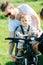 Attentive father carefully strapping his kid to bike baby chair